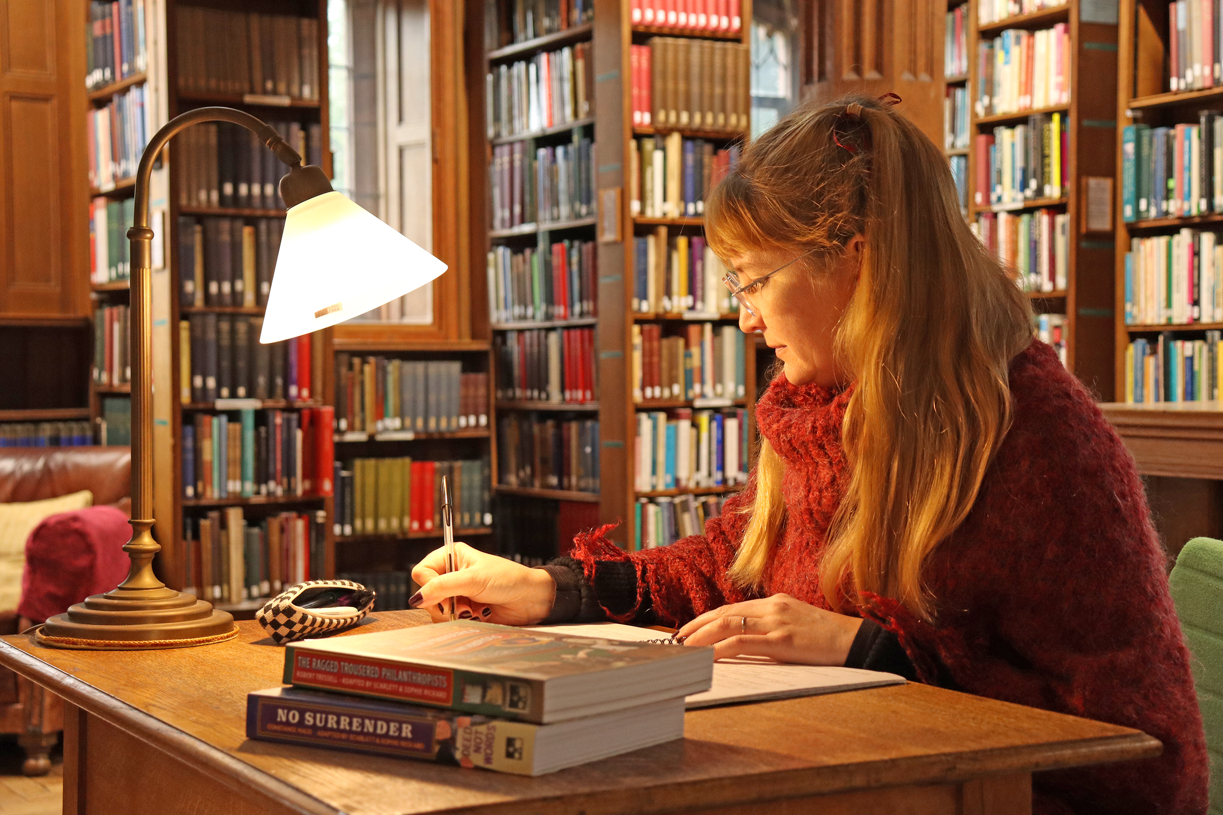 Sophie Rickard at a desk in the Reading Rooms